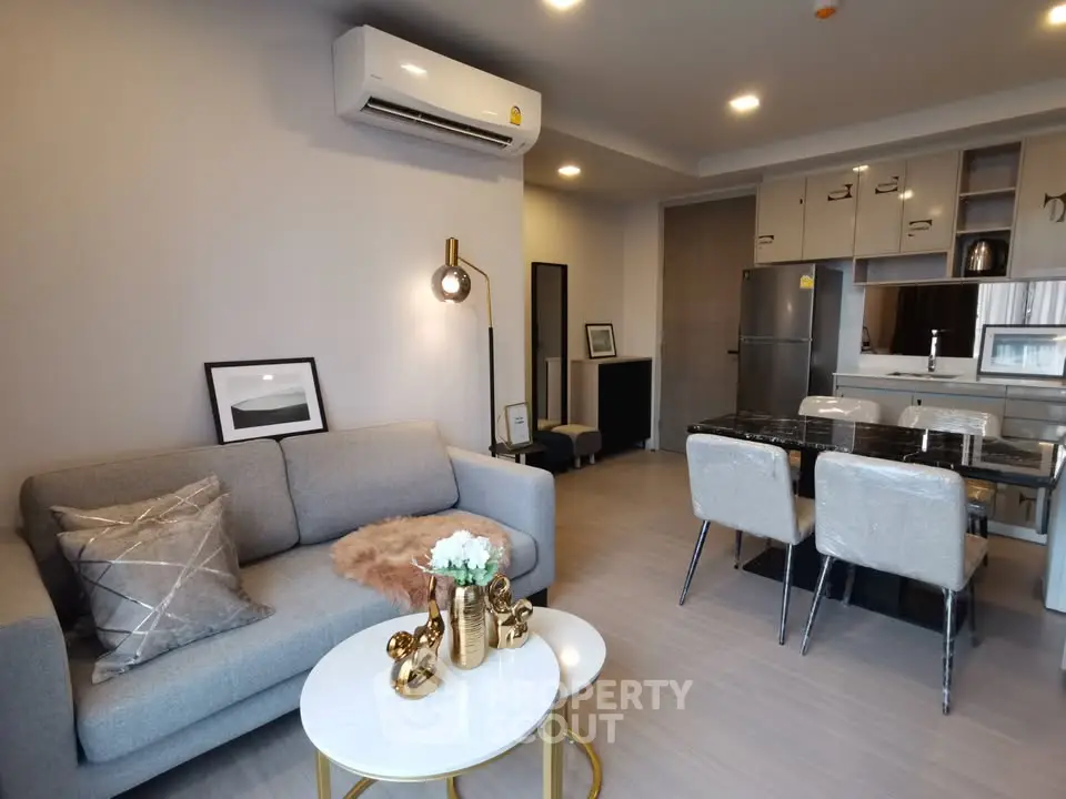 Modern living room with stylish decor and open kitchen layout in a contemporary apartment.