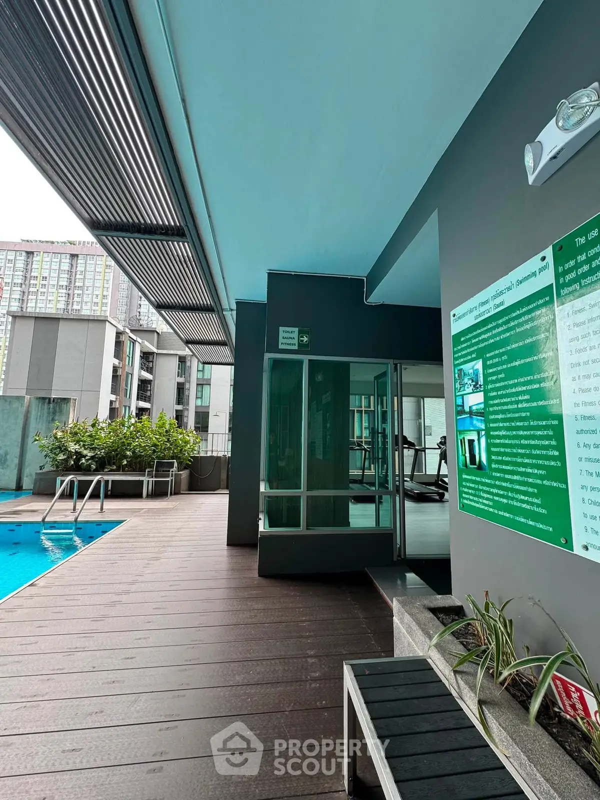 Modern apartment complex with pool and gym access, featuring sleek design and urban amenities.