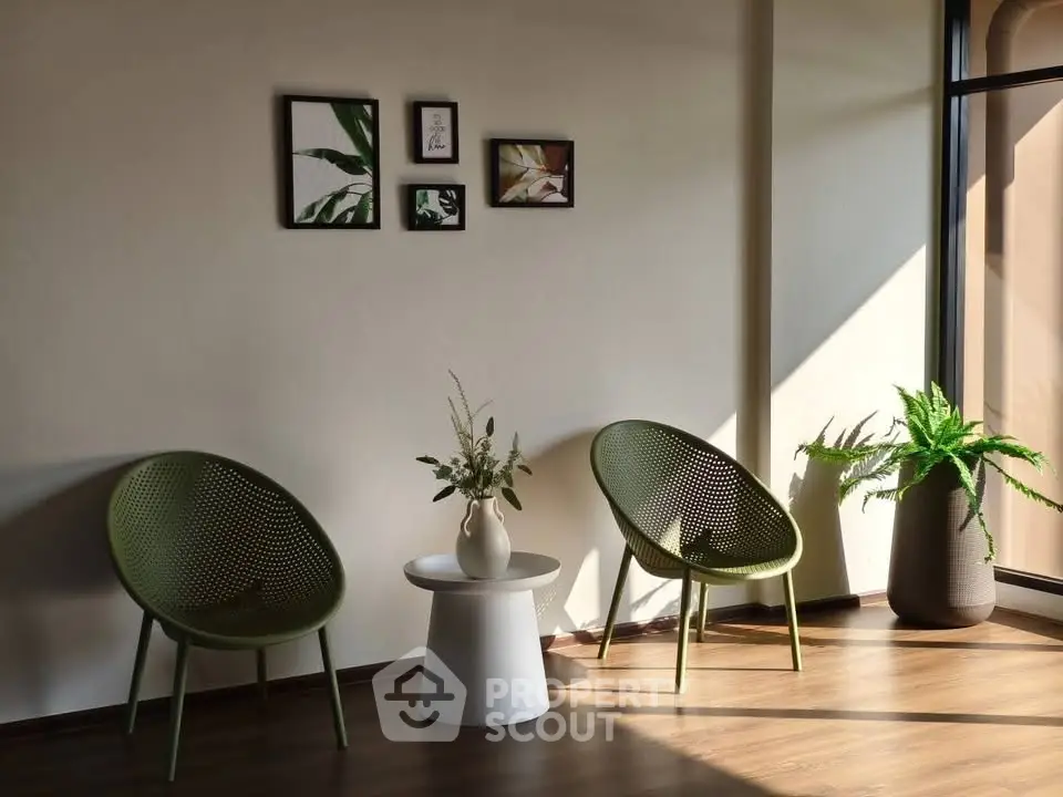 Stylish modern living room with green chairs and natural light