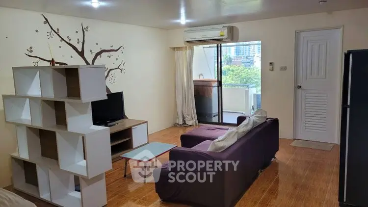 Spacious living room with modern decor and balcony view in urban apartment