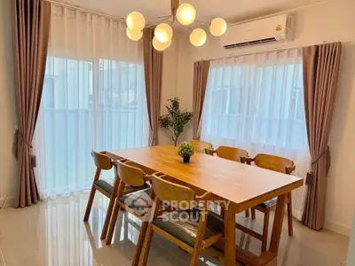 Elegant dining area with wooden table and modern lighting in a bright room.