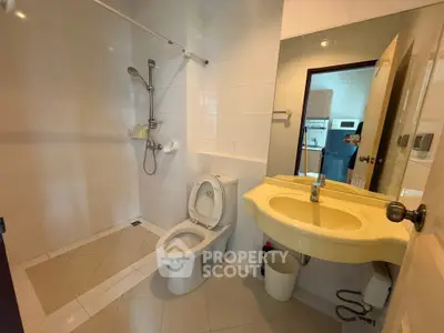 Spacious bathroom with modern fixtures and open shower design