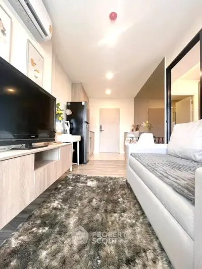 Modern living room with cozy sofa, stylish decor, and sleek TV setup.