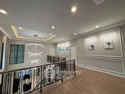 Elegant interior with modern lighting and stylish decor in a spacious hallway.