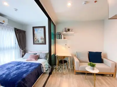 Modern studio apartment with cozy bedroom and stylish living area, featuring elegant decor and natural light.