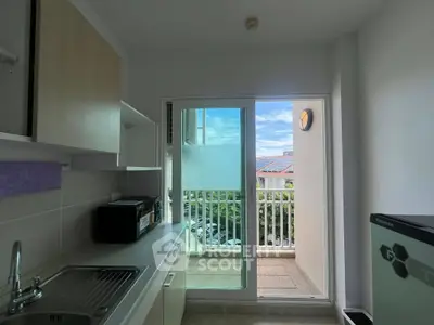 Modern kitchen with balcony view and sleek appliances