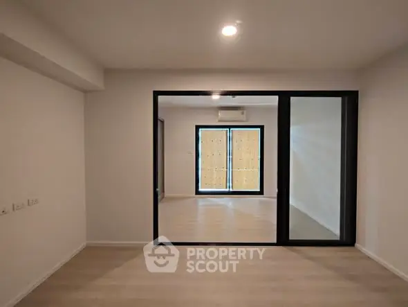 Spacious modern living room with sliding glass doors and natural light