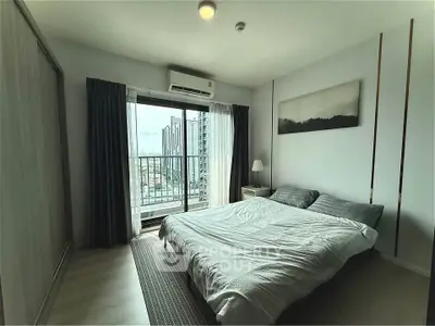 Modern bedroom with balcony view in high-rise apartment