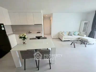 Modern open-plan living room with sleek kitchen and stylish furniture