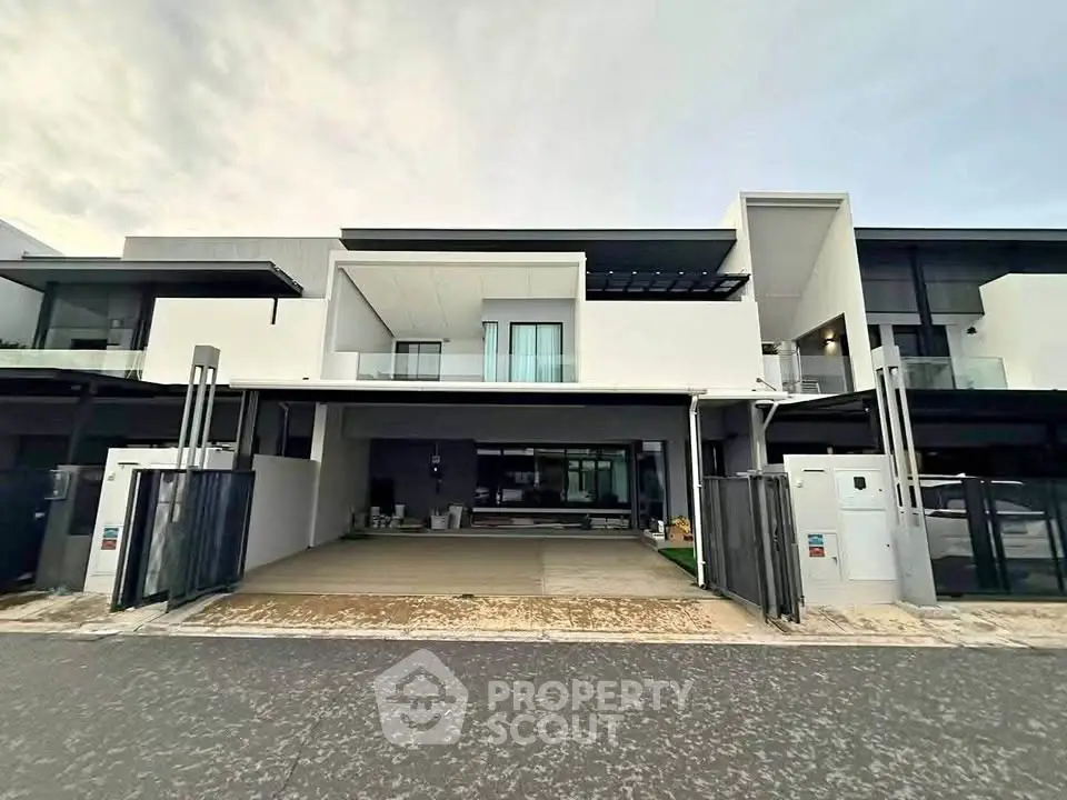 Modern two-story house with sleek design and spacious driveway