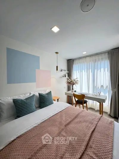 Chic bedroom with modern decor, large window, and cozy ambiance perfect for relaxation.