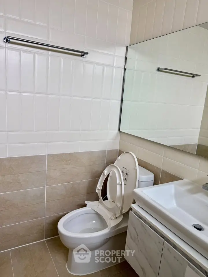 Modern bathroom with sleek fixtures and neutral tile design