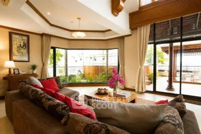 Luxurious living room with large windows and elegant decor, offering a spacious and inviting atmosphere.