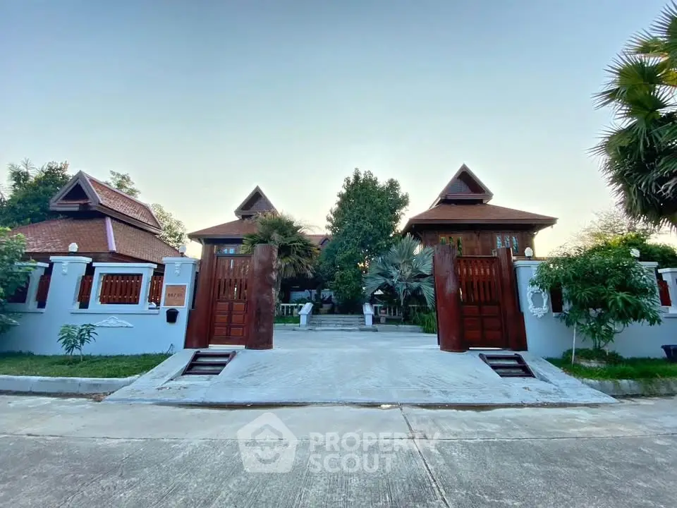 Stunning traditional-style villa with lush garden and elegant entrance, perfect for luxurious living.