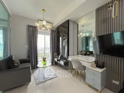 Modern living room with elegant decor, featuring a stylish chandelier, cozy sofa, and sleek TV setup.
