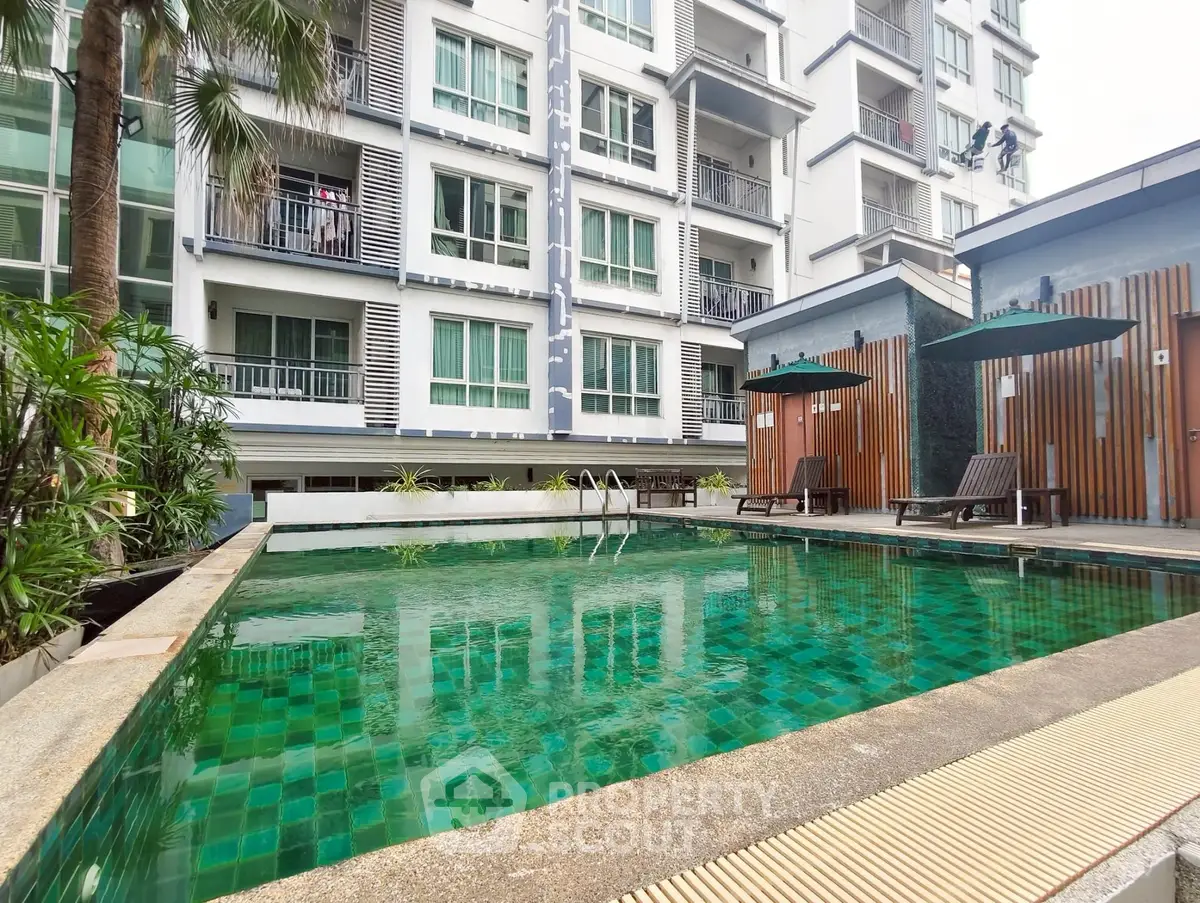 Luxurious condominium with a stunning pool and modern amenities for ultimate relaxation.