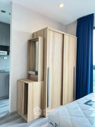 Modern bedroom with wooden wardrobe and natural light