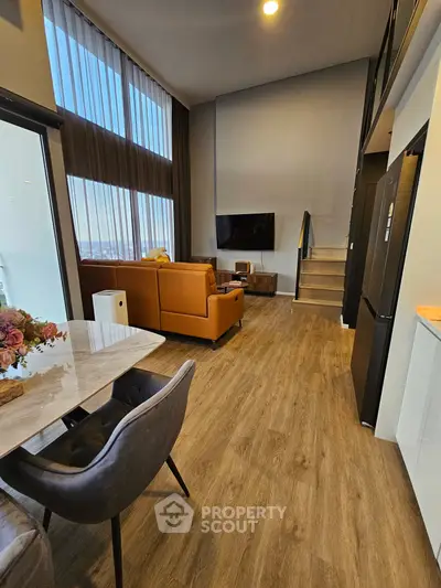 Modern loft-style living room with high ceilings and stylish decor