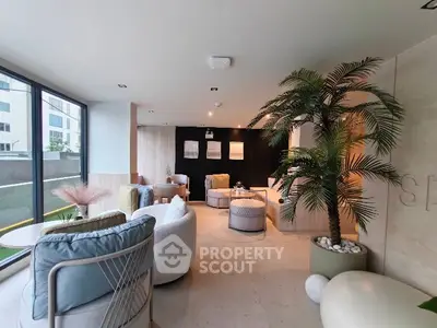 Modern living room with stylish furniture and large windows offering natural light.