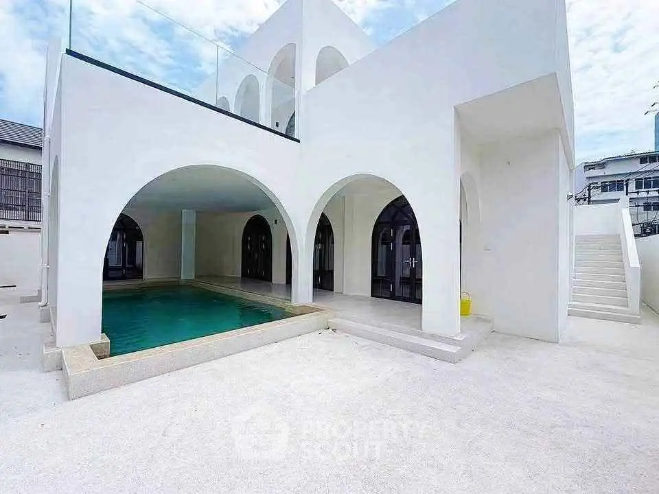 Stunning modern villa with private pool and elegant arches, perfect for luxury living.