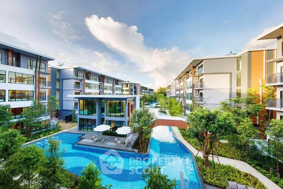 Luxurious modern apartment complex with stunning pool and lush greenery