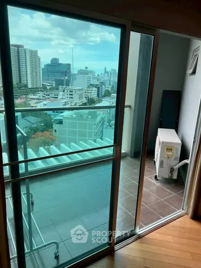 Modern apartment balcony with city view and air conditioning unit