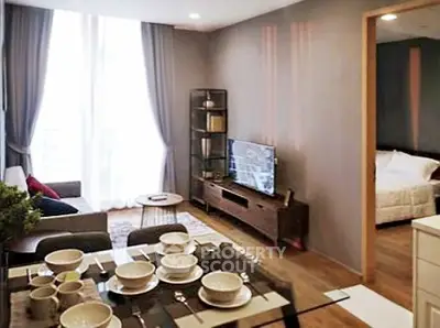 Modern living room with dining area and cozy bedroom view