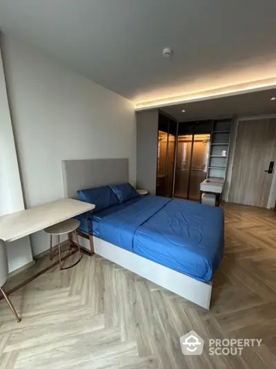 Modern bedroom with stylish herringbone flooring and sleek design