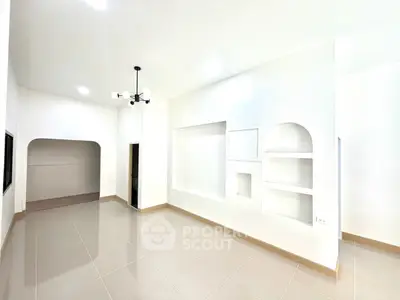 Spacious modern living room with elegant lighting and tiled flooring