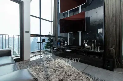 Luxurious living room with floor-to-ceiling windows and city view, featuring modern decor and plush rug.