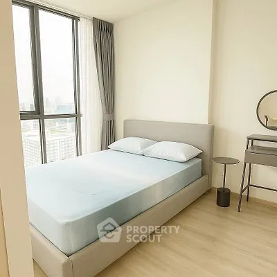 Modern bedroom with large window and minimalist decor in high-rise apartment.