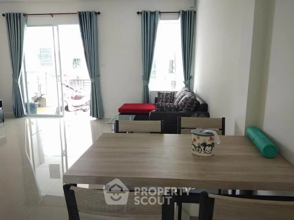 Spacious living room with modern furniture and large windows for natural light.