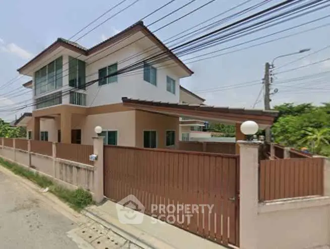 Spacious two-story house with modern design and fenced yard in a suburban neighborhood.