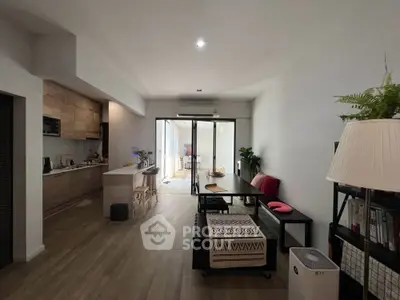 Spacious open-plan living and dining area with modern kitchen and natural light.