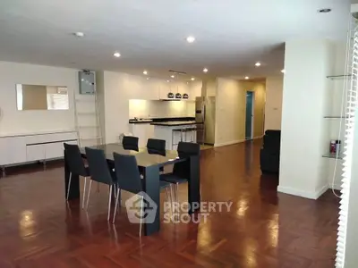 Spacious open-plan living and dining area with modern kitchen and sleek furnishings.