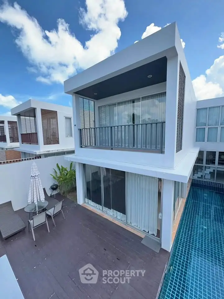 Modern two-story villa with private pool and spacious balcony, perfect for luxury living.