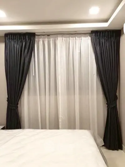 Elegant bedroom with luxurious curtains and soft lighting, perfect for a cozy and stylish retreat.