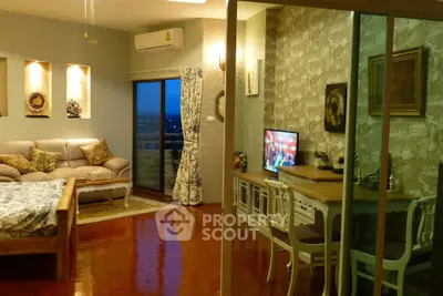 Charming living room with cozy decor and balcony view, perfect for relaxation and entertainment.