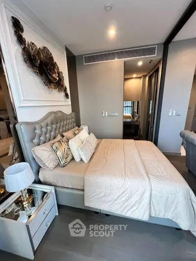 Luxurious bedroom with elegant decor and plush bedding in modern apartment