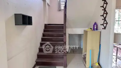 Charming staircase with wooden steps and storage area in cozy home