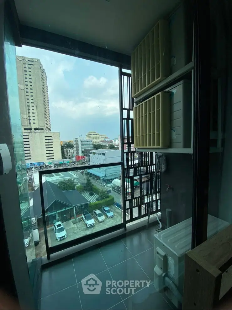 Modern apartment balcony with city view and laundry area