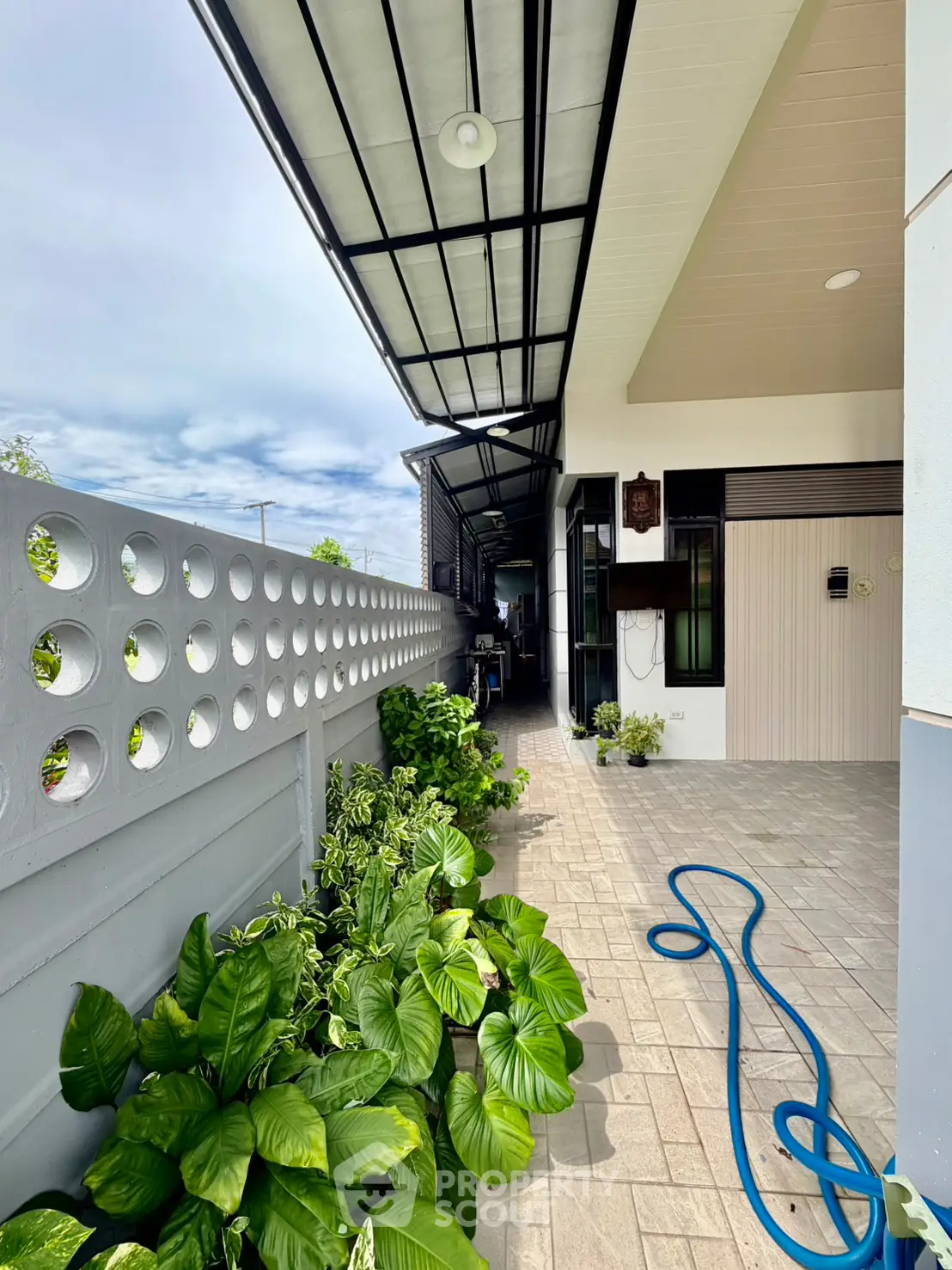 Modern exterior patio with lush greenery and stylish design, perfect for relaxation and outdoor enjoyment.
