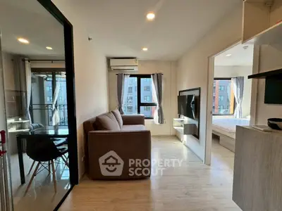 Modern apartment living room with cozy sofa and large windows offering city views.