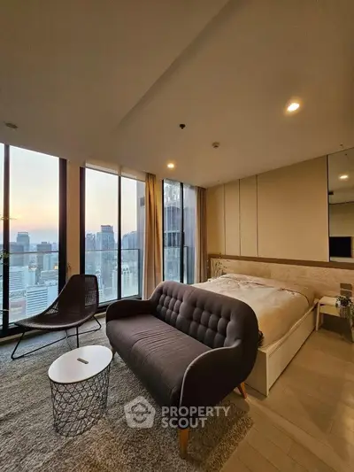 Luxurious bedroom with stunning city view, featuring modern decor and cozy seating area.