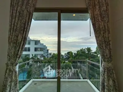 Stunning balcony view with lush greenery and pool in a modern residential complex.