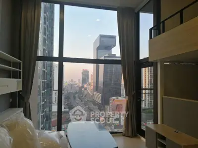 Modern high-rise apartment with stunning city view and floor-to-ceiling windows.