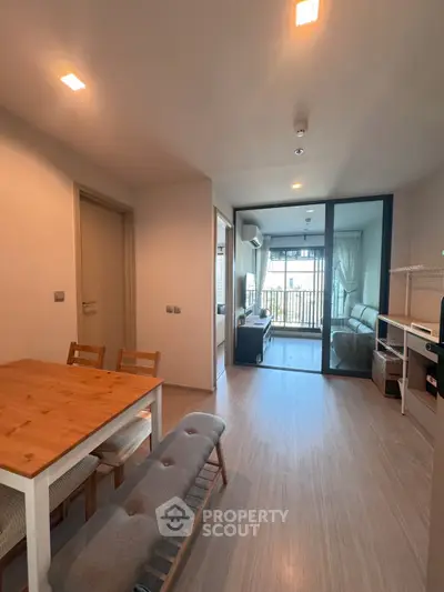 Modern living room with dining area and balcony view