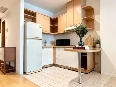 Charming kitchen with open layout and modern appliances in cozy apartment.
