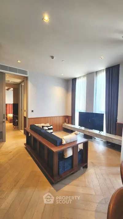 Luxurious living room with modern decor and large windows offering natural light.