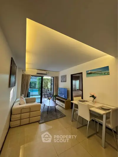 Modern living room with pool view, stylish furniture, and elegant lighting in a luxury apartment.